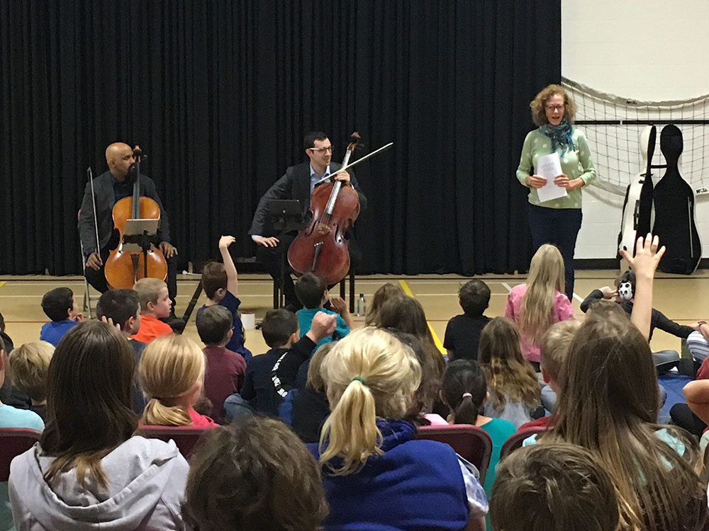 Inspiring music education from VC2 Cello Duo as they perform at a High River Gift of Music school concert.