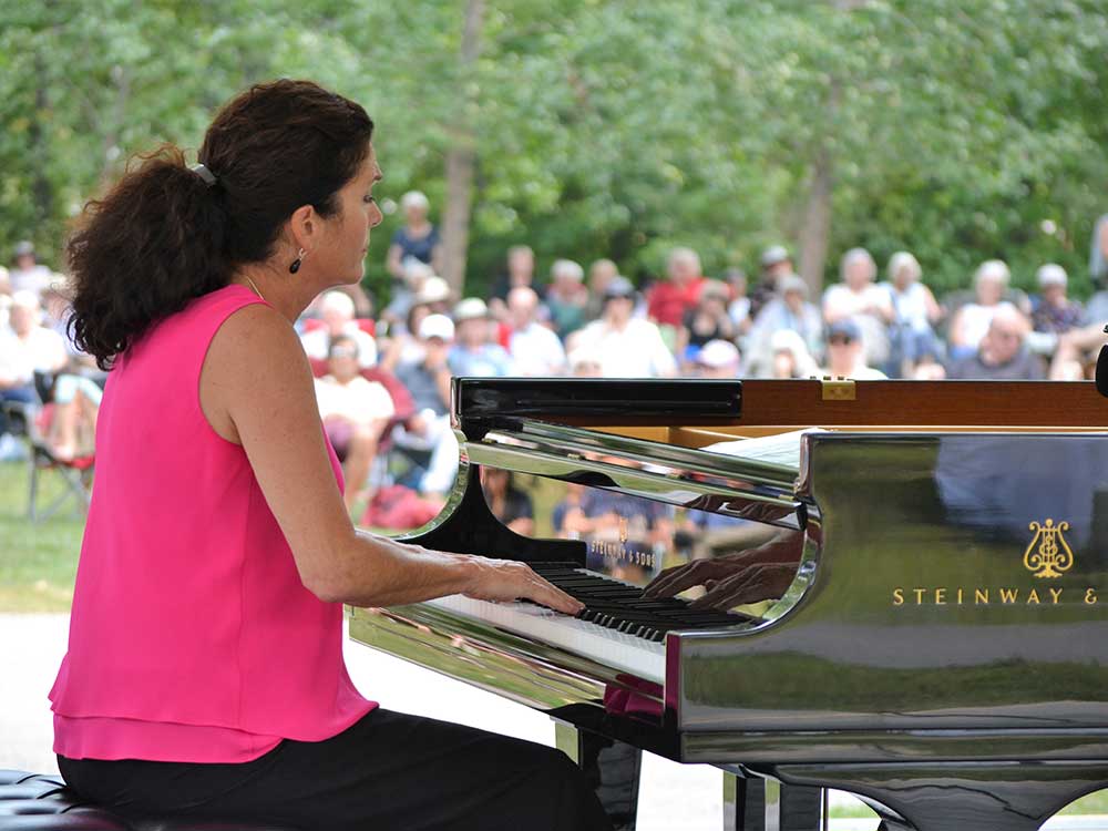 Elizabeth Bergmann plays piano at the Honens outdoor concert 2022 outreach event